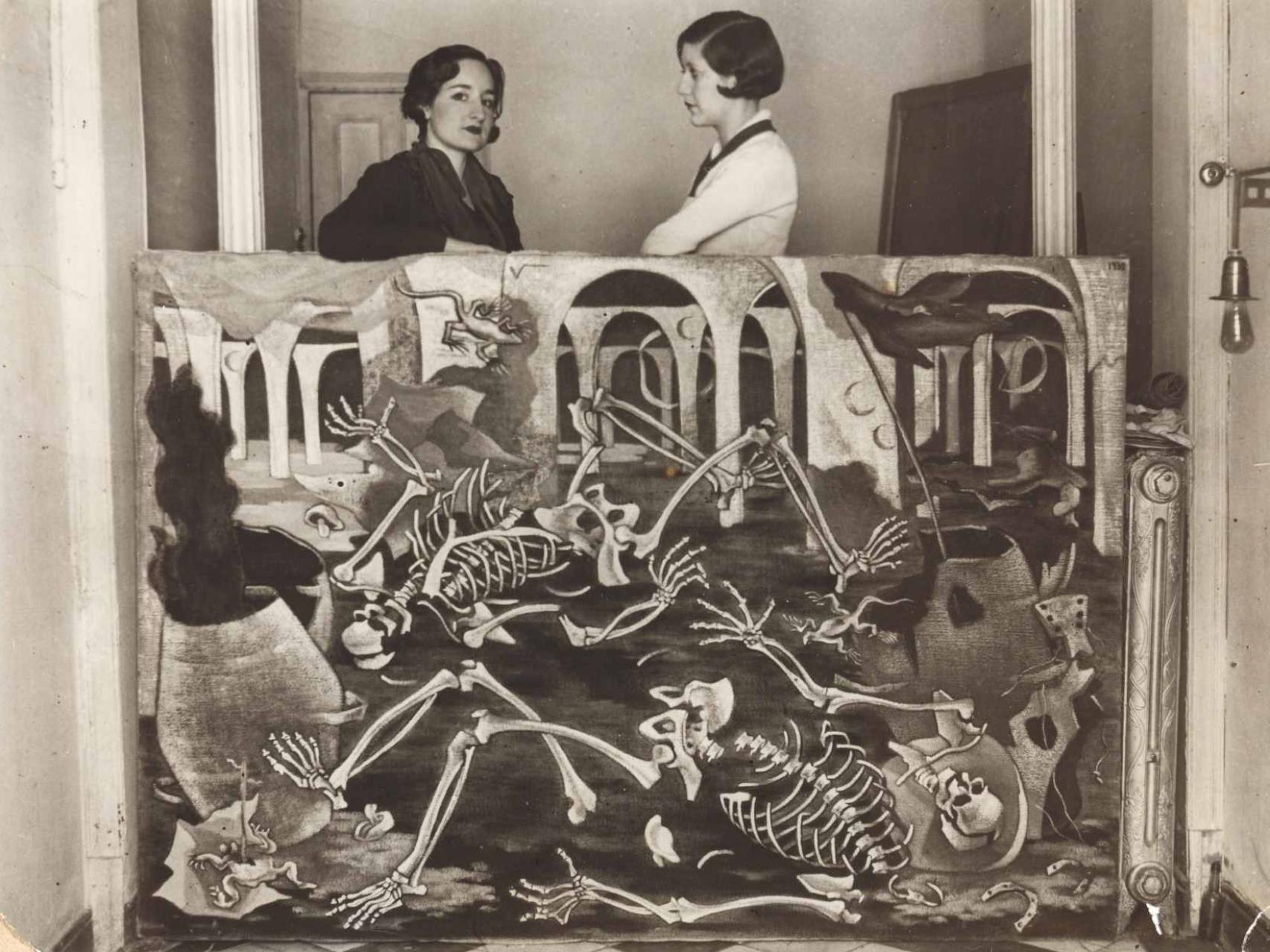 Maruja Mallo con Josefina Carabias, apoyadas sobre su óleo ‘Antro de fósiles’.