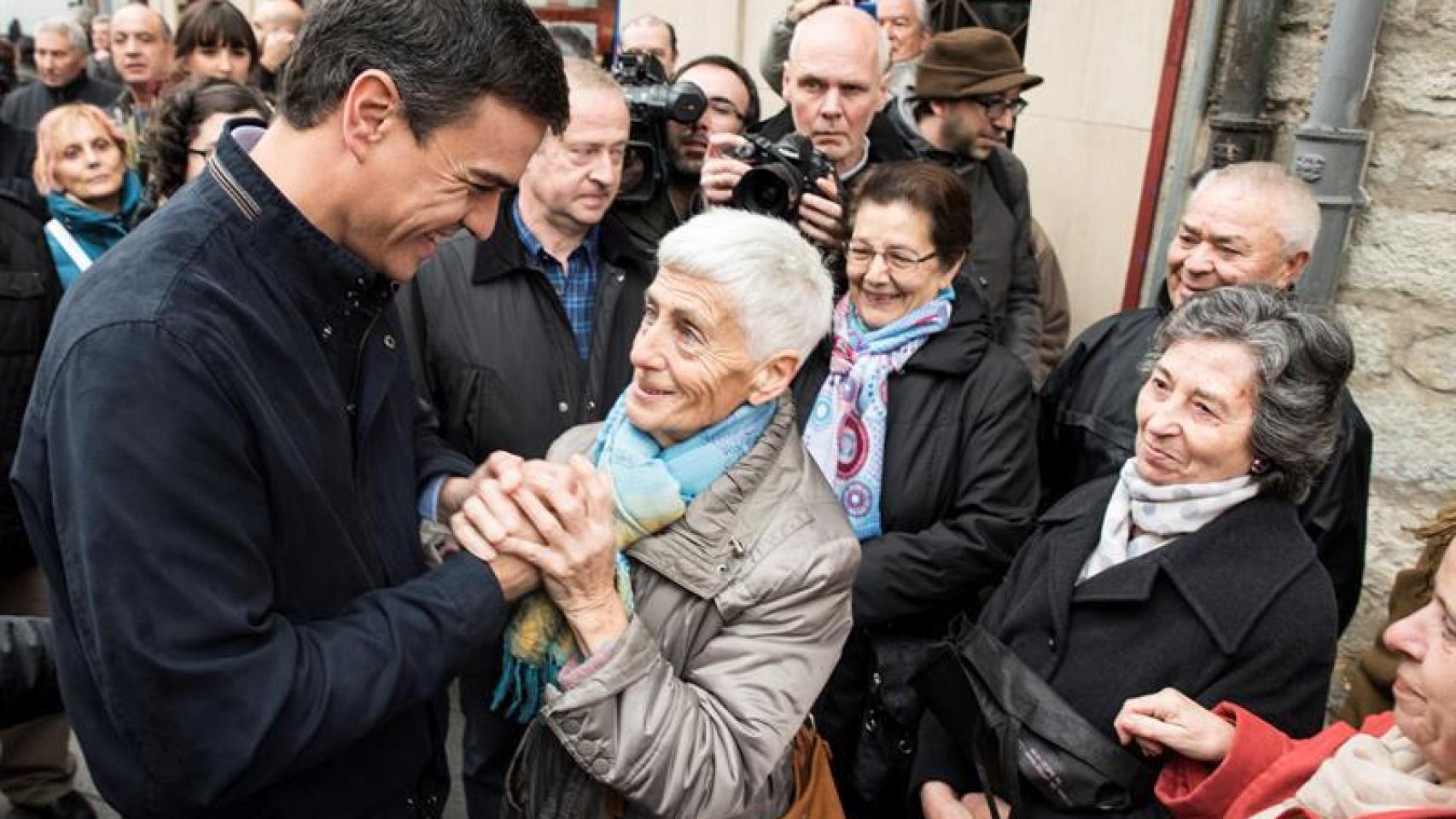 Pedro Sánchez, en pleno acto, saluda a una simpatizante.
