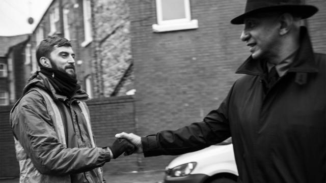 French saluda a un trabajador.