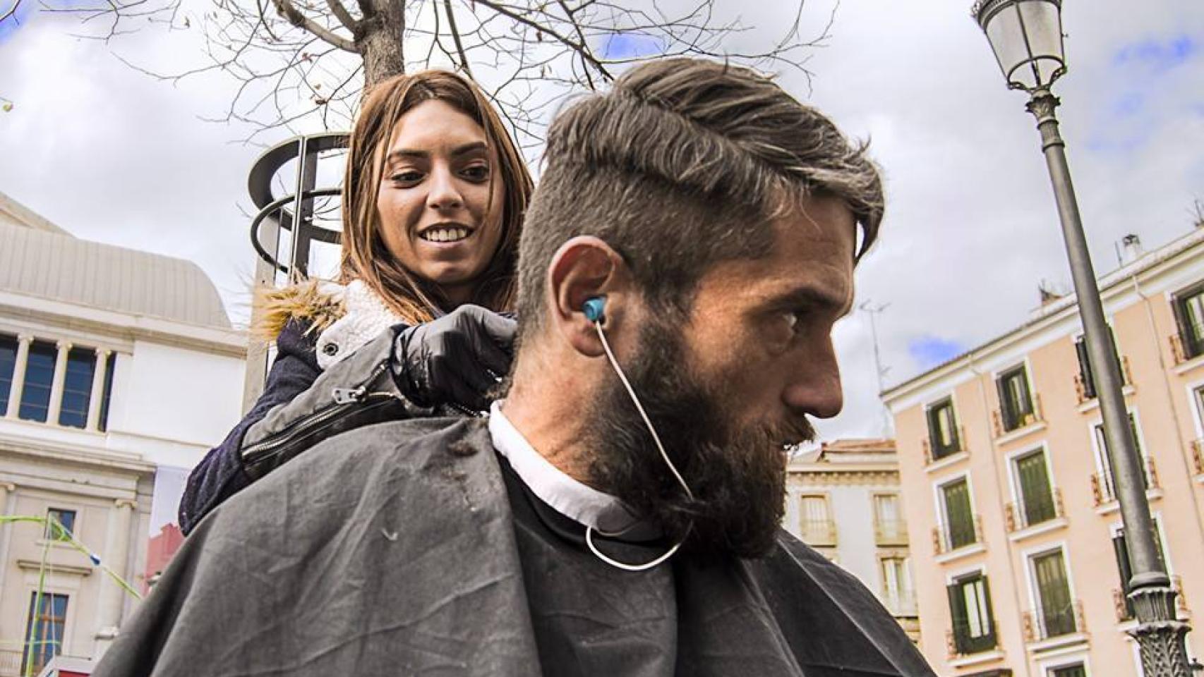 Ana corta el pelo a Eduardo, gallego de 38 años, en Ópera (Madrid)