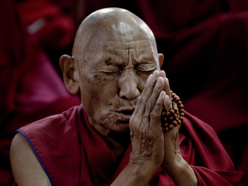 Palden Gyatso estuvo 33 años preso en las cárceles chinas de Tíbet. Escapó cruzando el Himalaya a pie y denunció las torturas sufridas en su libro 'Fuego bajo la nieve'. En la imagen, reza en el monasterio de Namgyal Monastery, en Dharamsala,  por sus compatriotas inmolados (143 hasta la fecha).