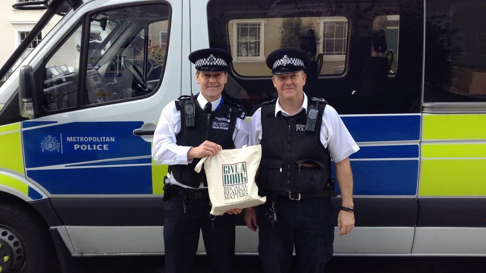 El agente Steve Whitmore junto con otro compañero y los libros de la iniciativa.