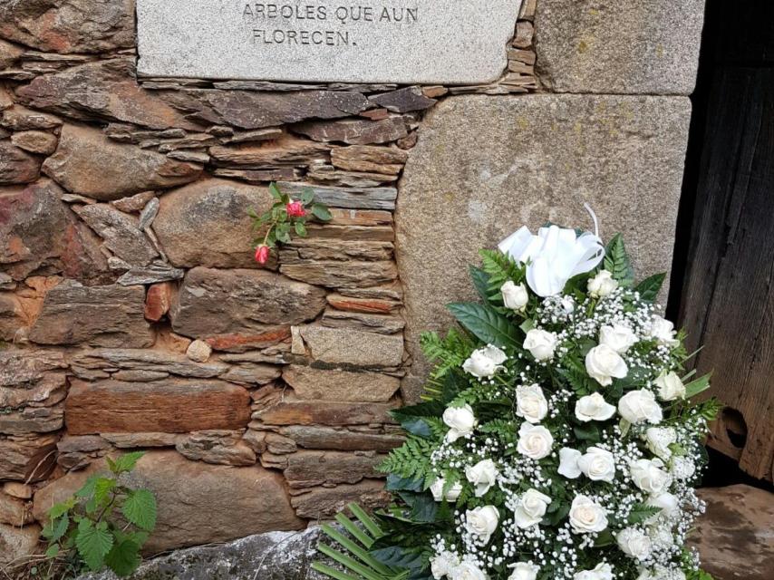 Los asistentes han dejado una corona de flores ante la casa familiar.