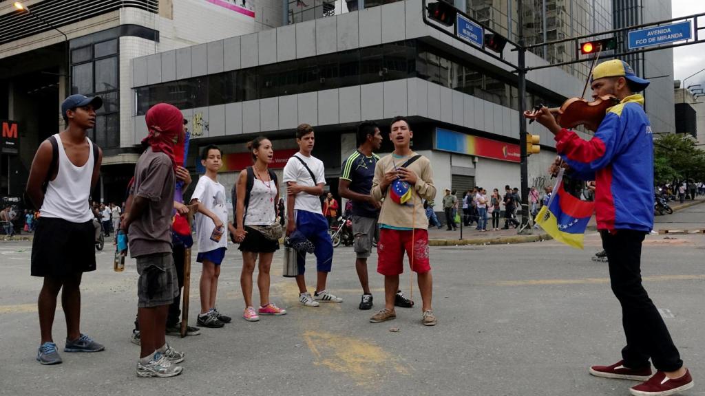 Wuilly Aretaga toca el violín durante las protestas contra Maduro.