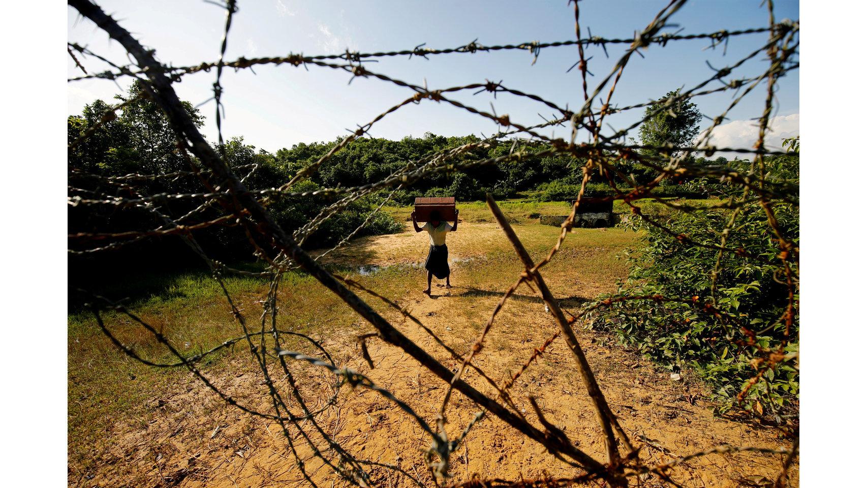 A Rohingya man carrying his belongings approaches the Bangladesh-Myanmar border in Bandarban, an area under Cox's Bazar authority  Mohammad Ponir Hossain