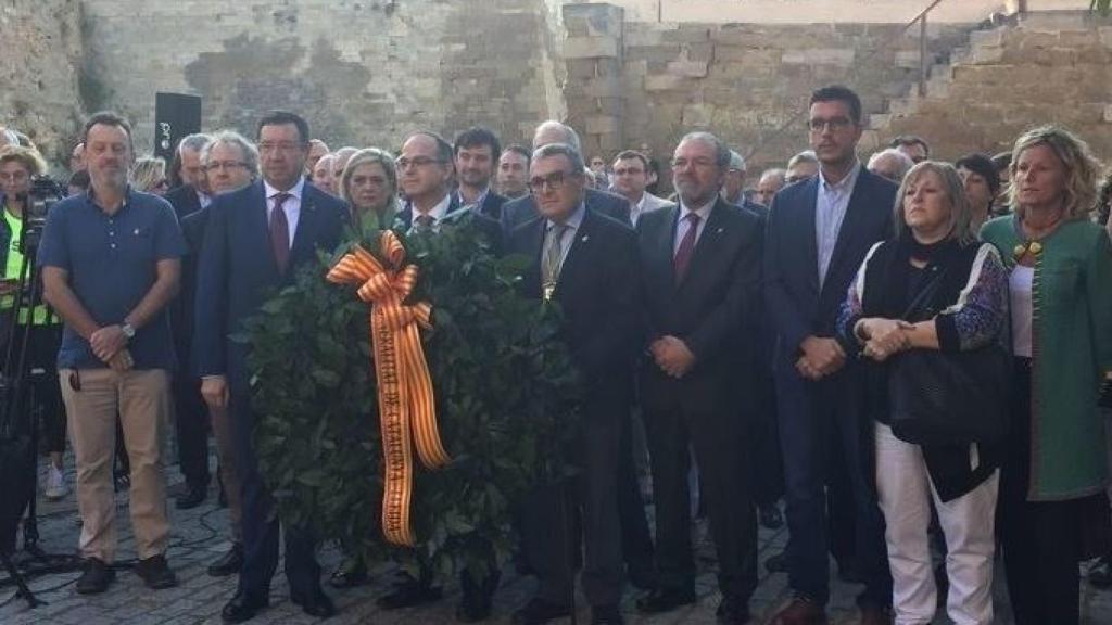 Jordi Turull, portavoz de la Generalitat, en el centro de la imagen sosteniendo una corona de flores. Foto: Europa Press