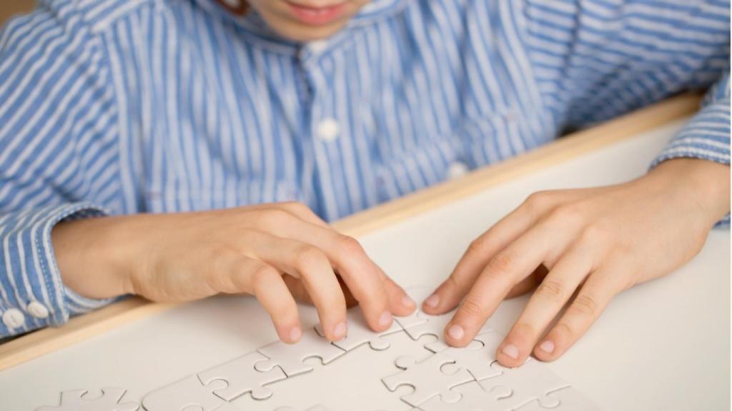 Un joven montando un puzzle