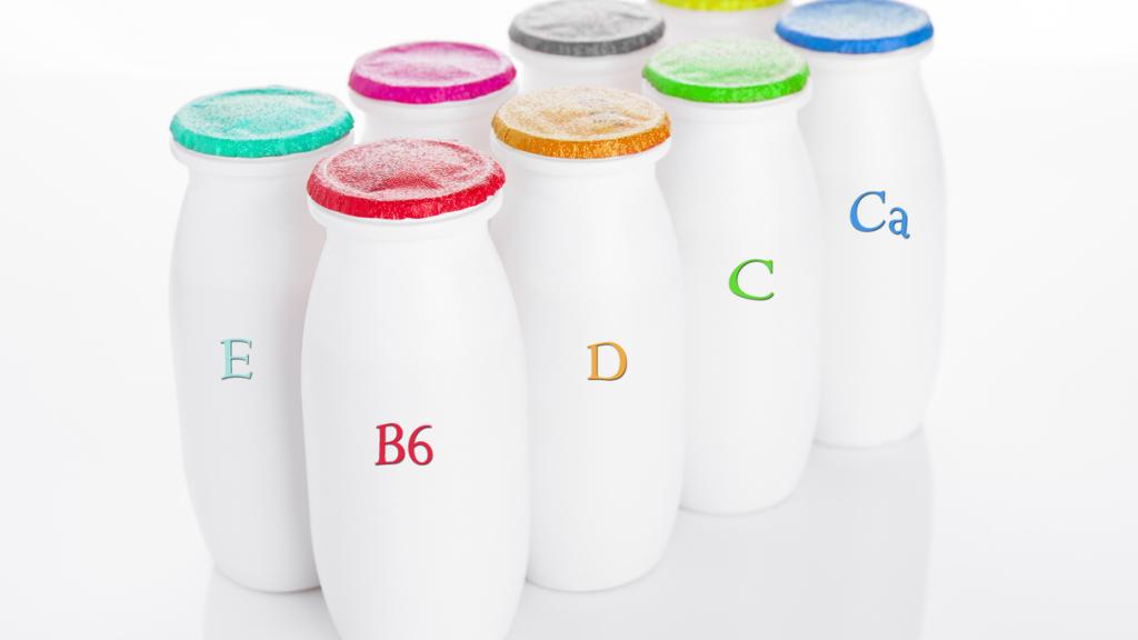 Yogurt containers healthy vitamin drink on white