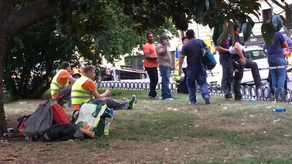 Dos operarios en estado de shock comen pipas ante el escenario del desastre