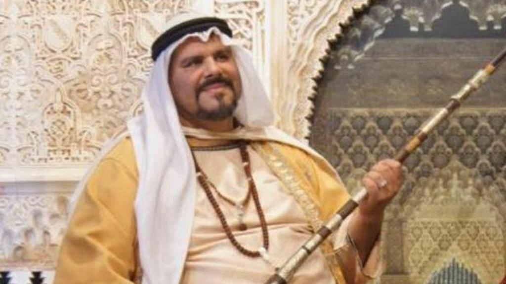 Lama Losel posa para las cámaras caracterizado como una suerte de jeque árabe, rifle en mano.