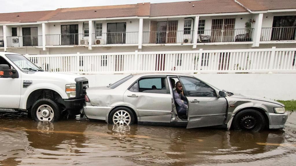 Un coche en una carretera inundada.