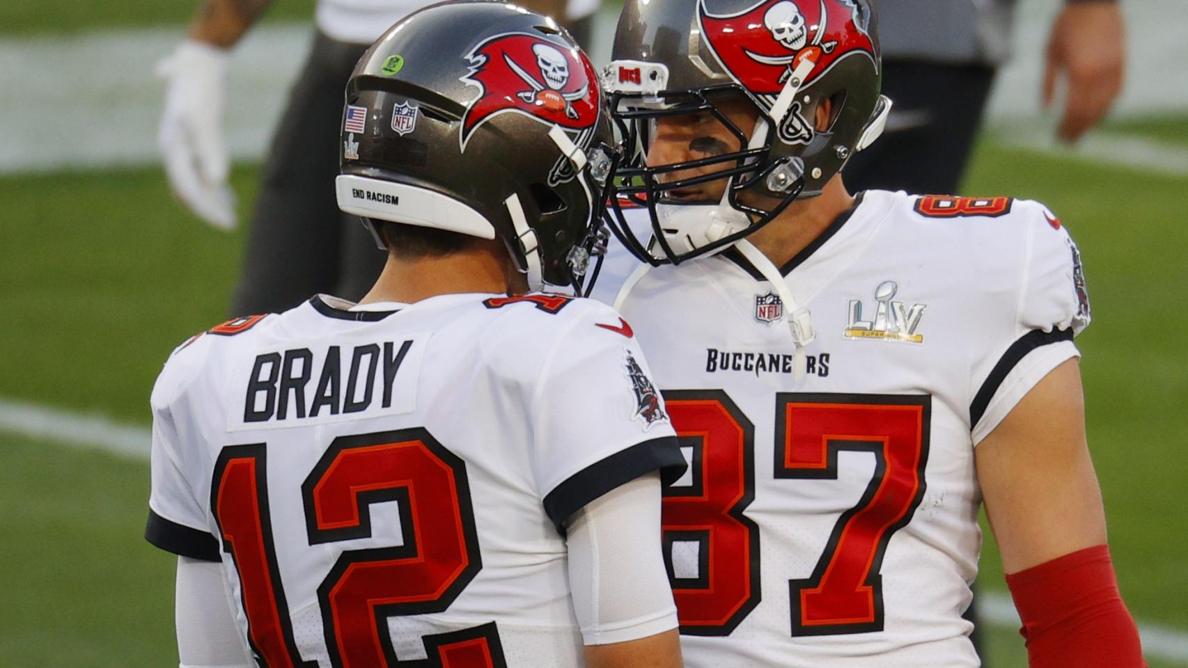 Tom Brady y Rob Gronkowski chocan sus cascos durante el partido