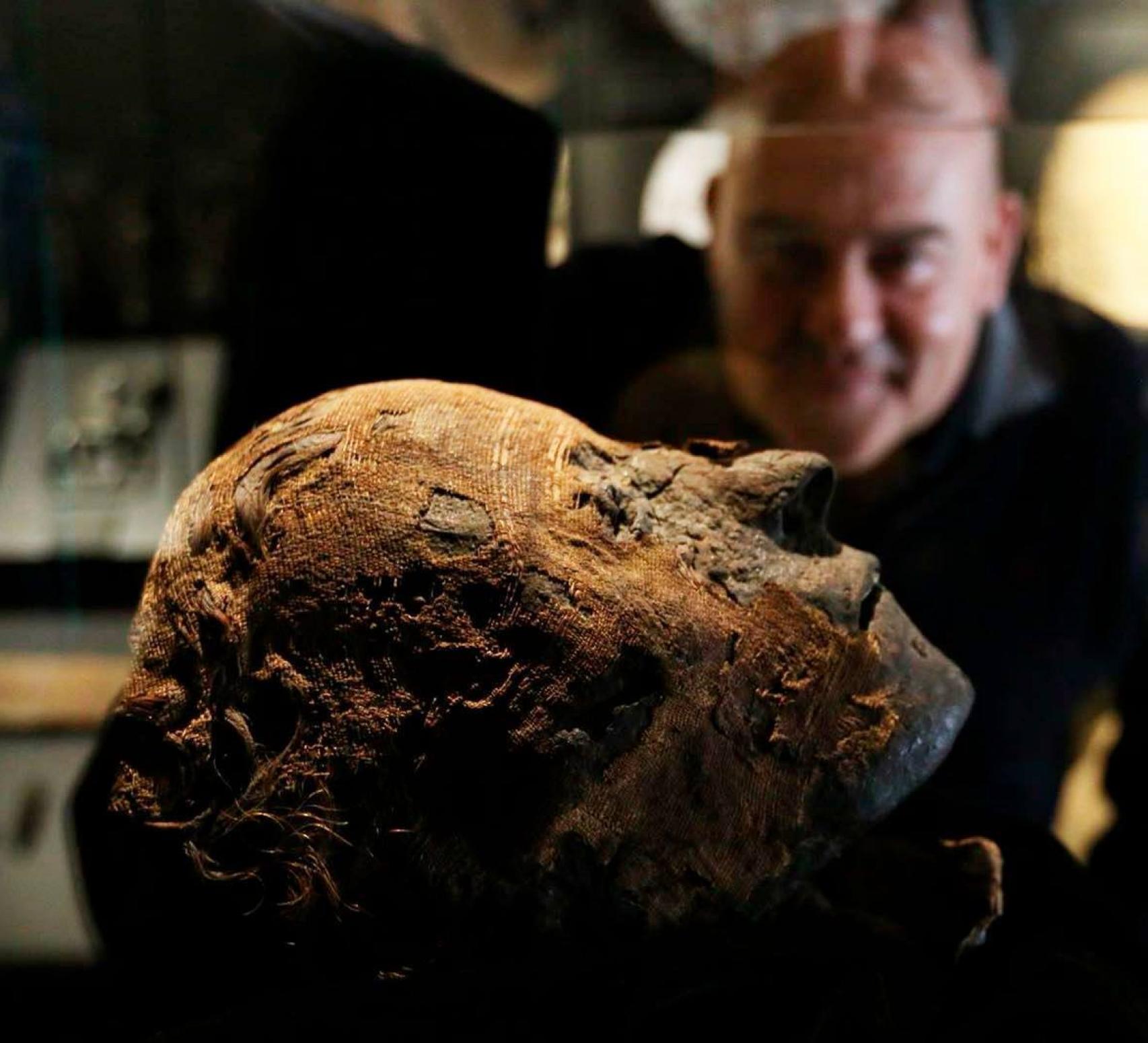 Vicente Jiménez observa la cabeza de la momia Nefer.