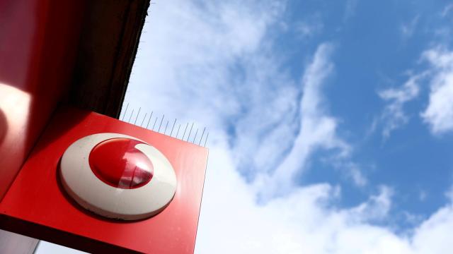 FILE PHOTO: A branded sign is displayed on a Vodafone store in London