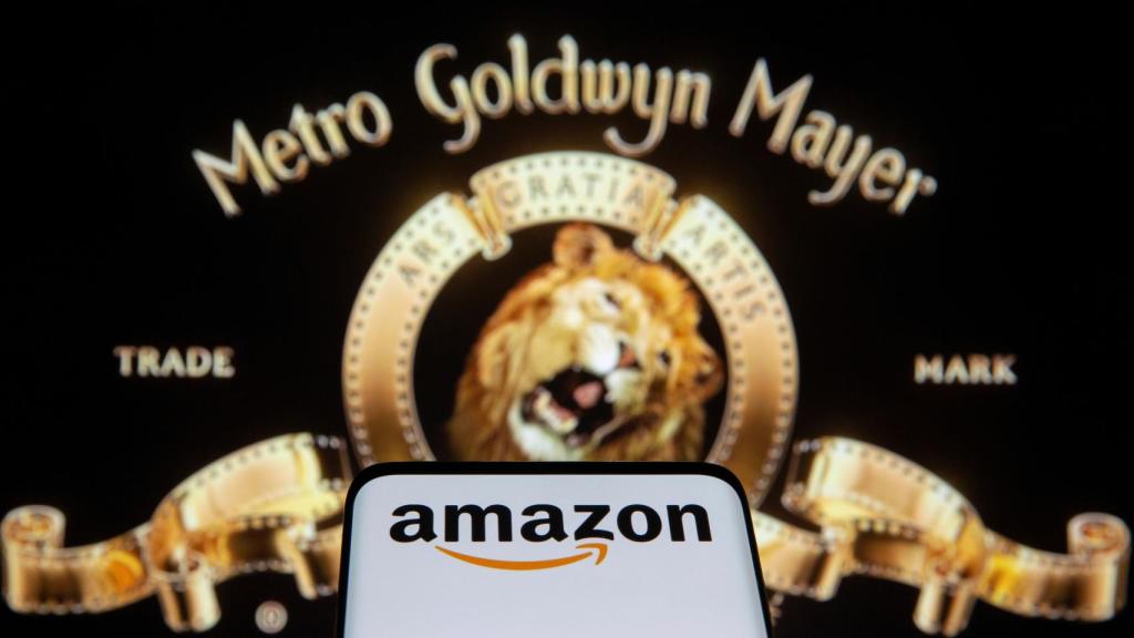 Smartphone with Amazon logo is seen in front of displayed MGM logo in this illustration taken