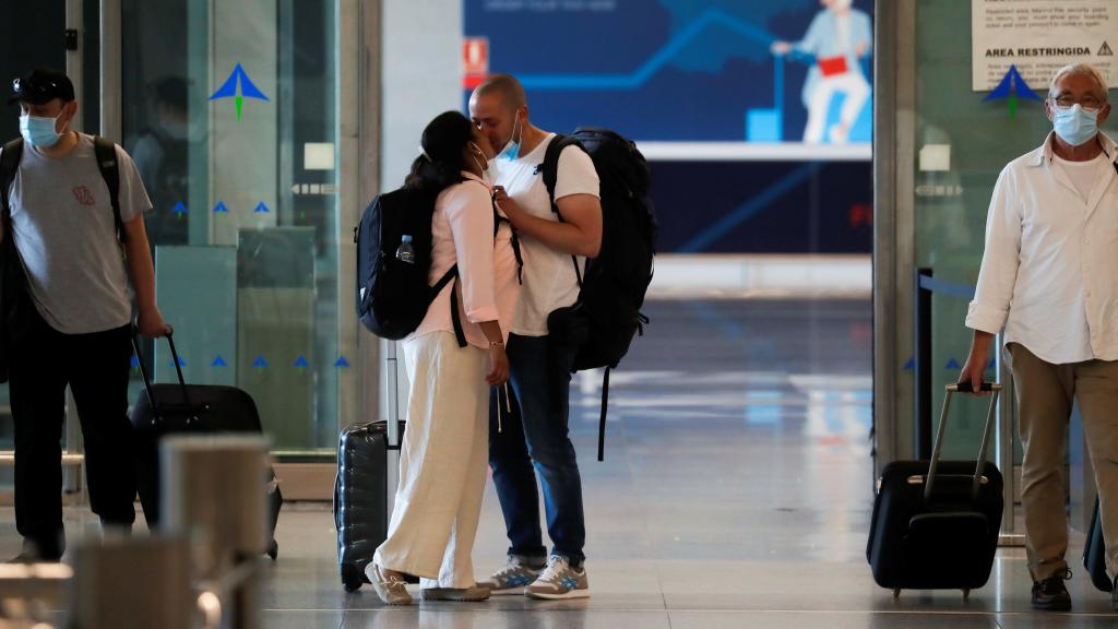 Una pareja se besa al llegar al aeropuerto de Málaga. Jon Nazca / Reuters.
