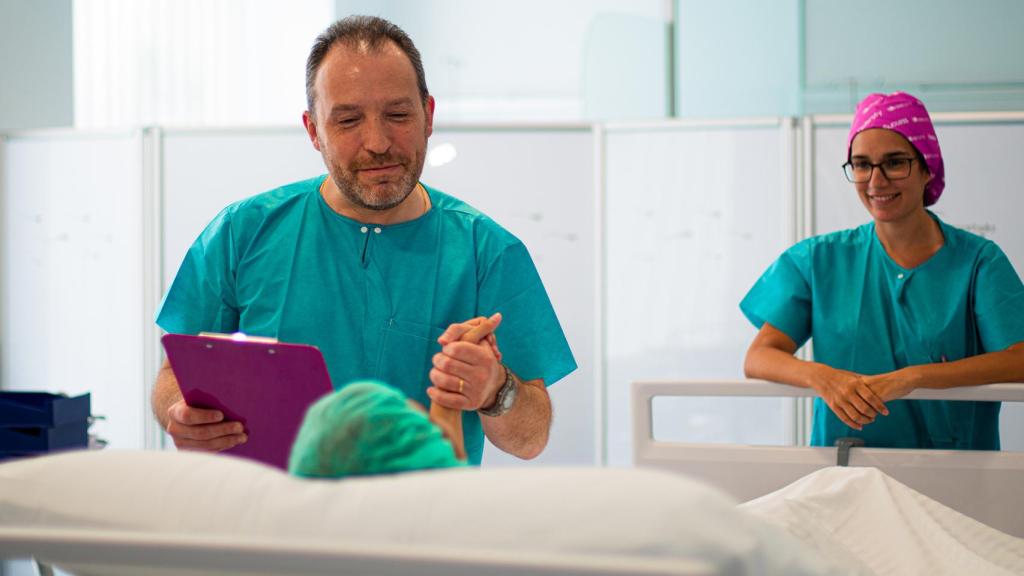 Dos profesionales atendiendo a una paciente.