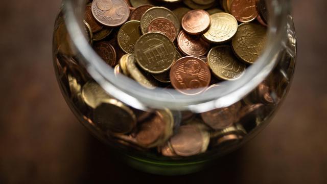 Un frasco con monedas de euro de distintas denominaciones.