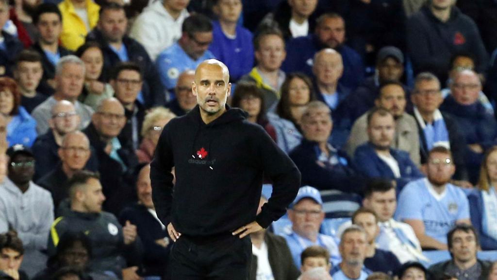 Guardiola, brazos en jarra ante la afición del Manchester City