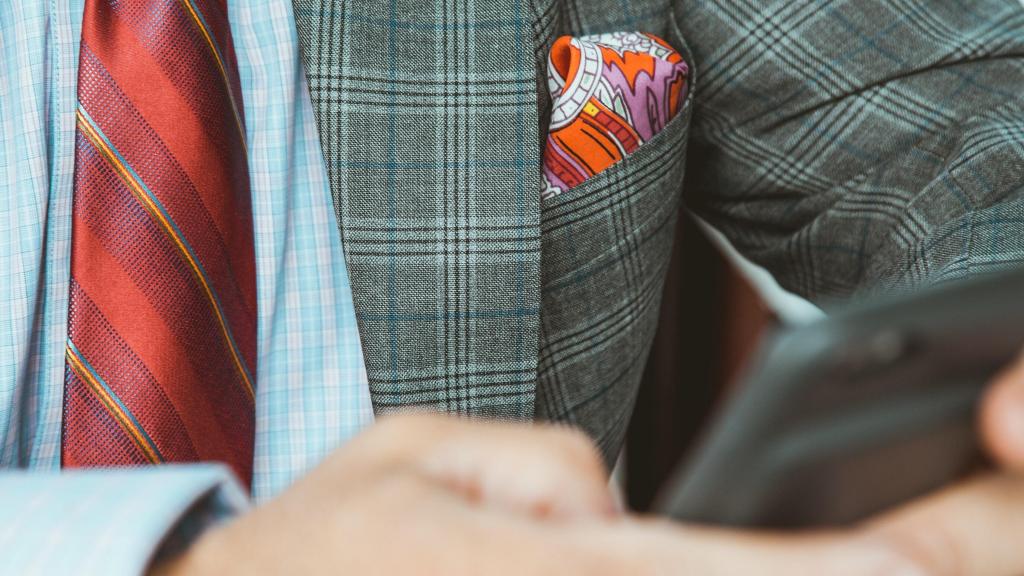 Un ejecutivo mientras consulta su teléfono móvil.