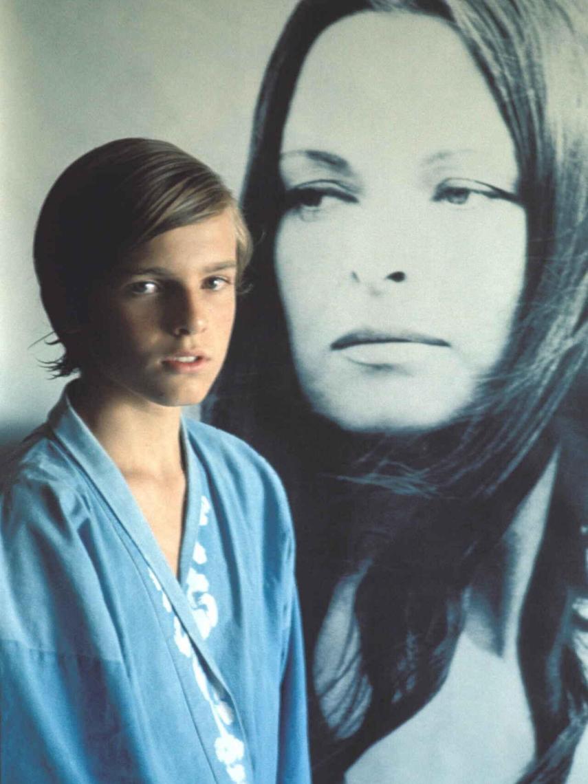 Miguelito junto a un retrato de su madre.