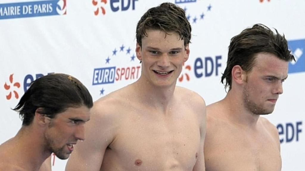 Yannick Agnel en un podio junto a Michael Phelps