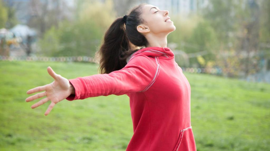Una mujer practica deporte en un parque.