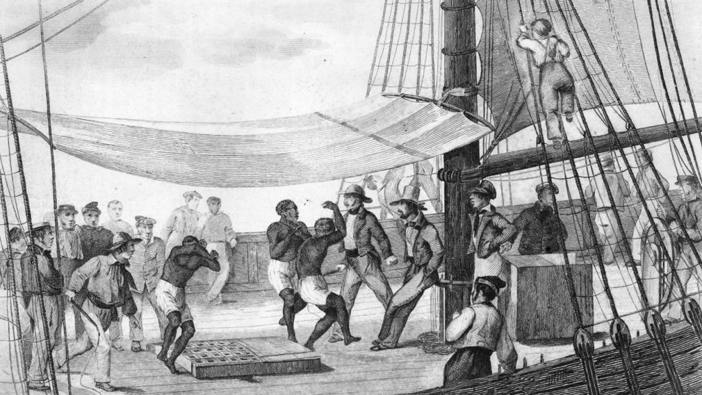 Una escena en un barco negrero con esclavos bailando entre marinos con látigos.