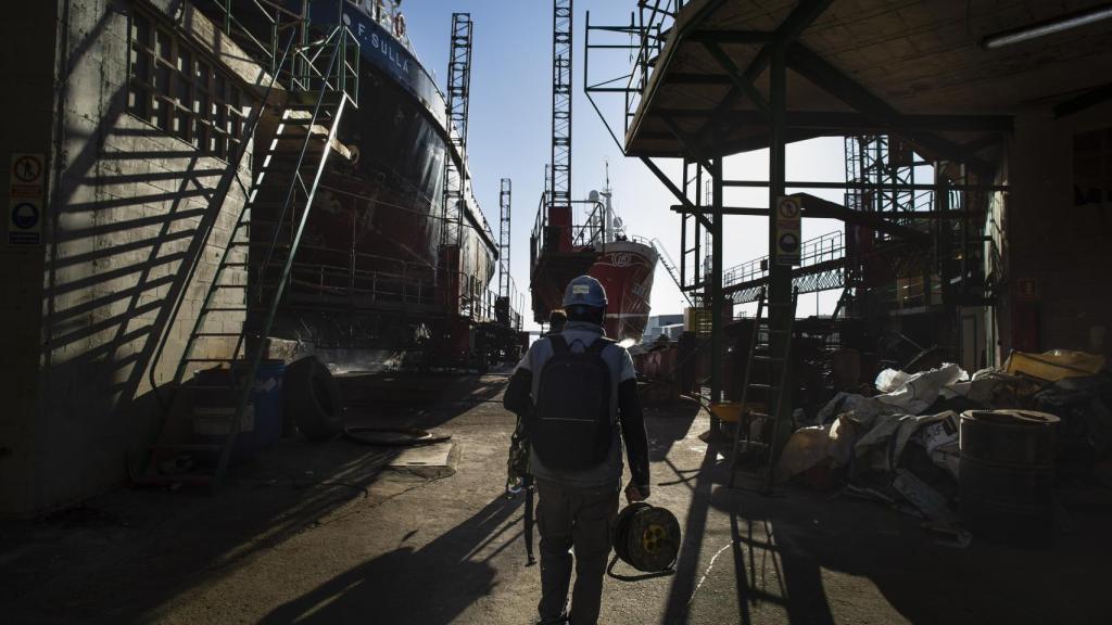 Un hombre entra a trabajar en el puerto por la mañana.