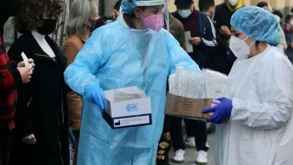 Enfermeras junto a una cola para hacerse el test de antígenos contra la Covid.