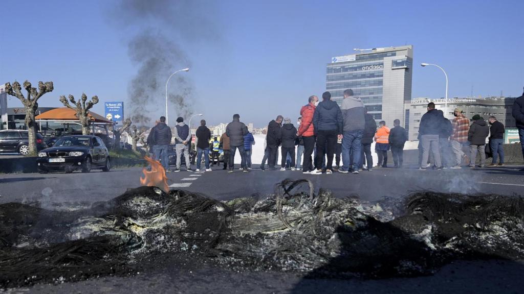 Quema de neumáticos en la avenida de Alfonso Molina de A Coruña en una protesta de trabajadores de Alu Ibérica.