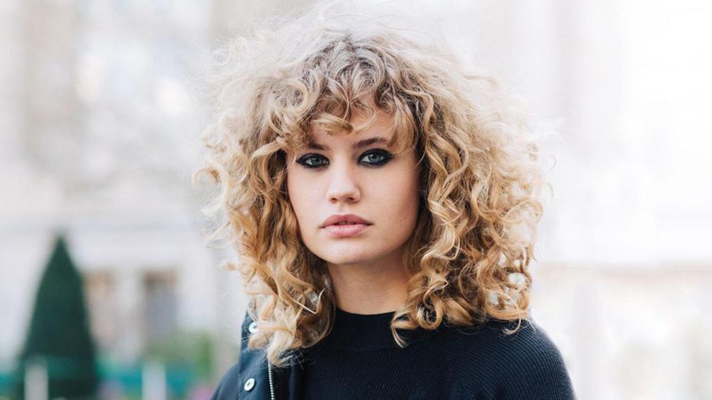 Una modelo luciendo su melena rizada y bien hidratada.