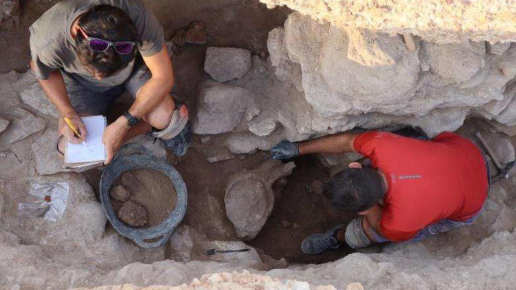 Dos personas trabajando en el yacimiento.