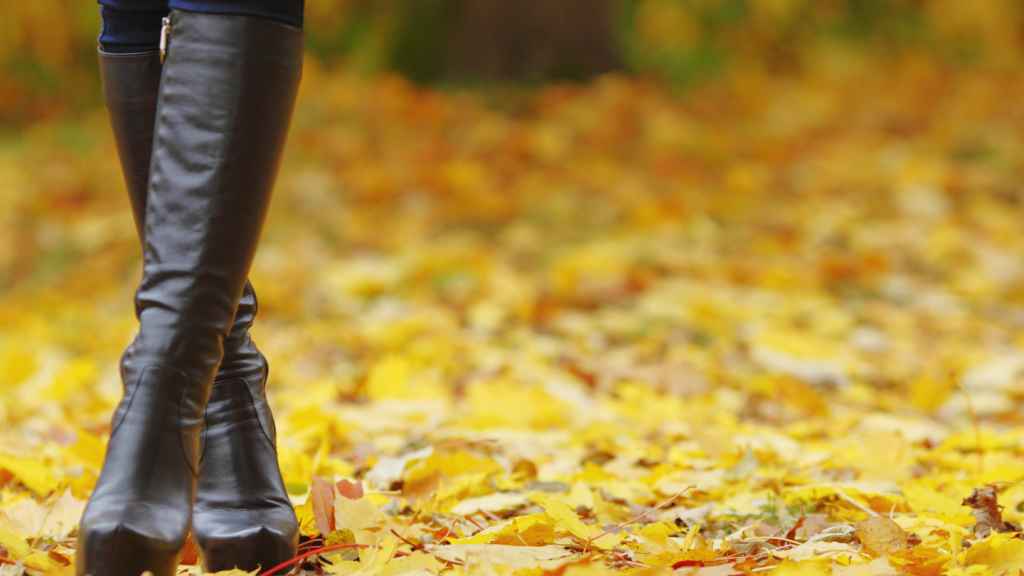 Una mujer mira su armario de zapatos indecisa.