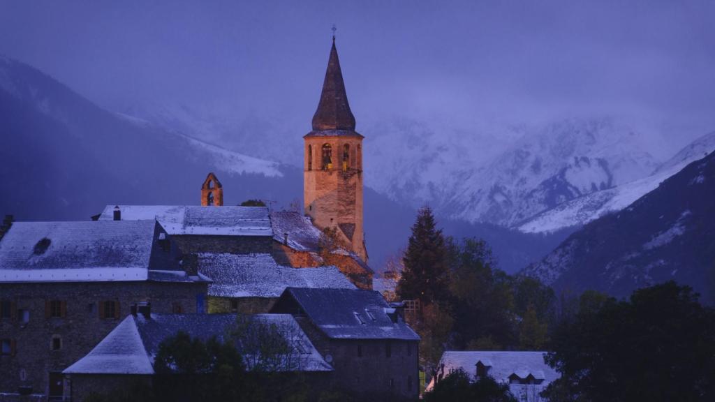 Campanario de Santa Eulària d'Unha tras una ligera nevada en el Valle de Arán