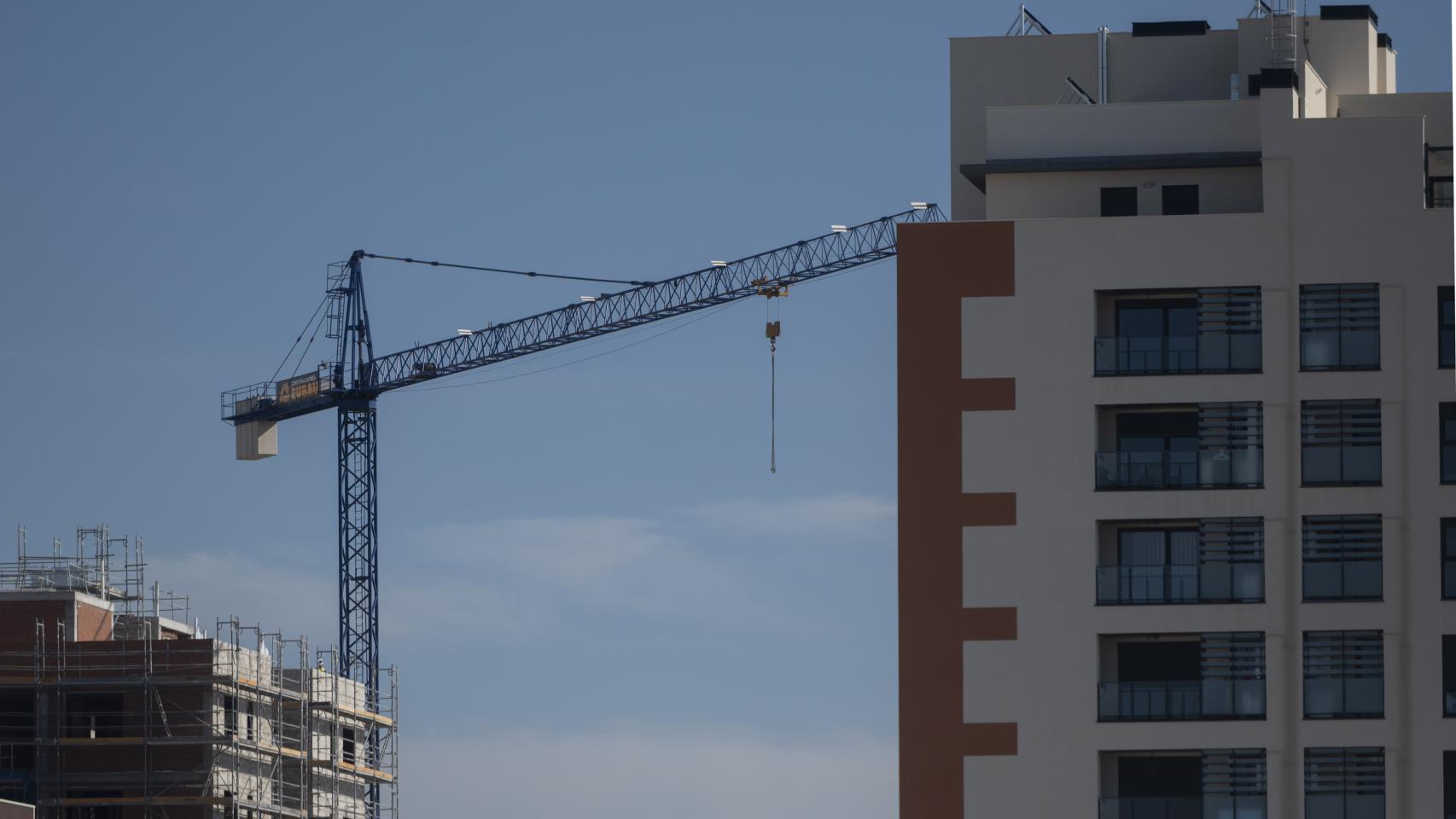 Una grúa en una vivienda en construcción.