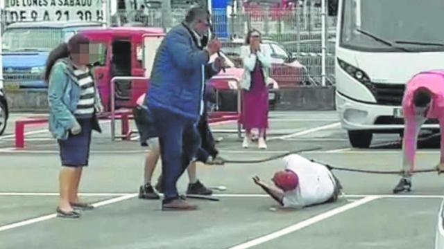 El  vigilante permanece en el suelo mientras es agredido con barras de hierro por tres hombres.