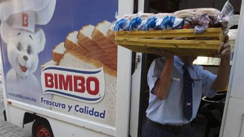 Un empleado de Bimbo llevando una bandeja de productos