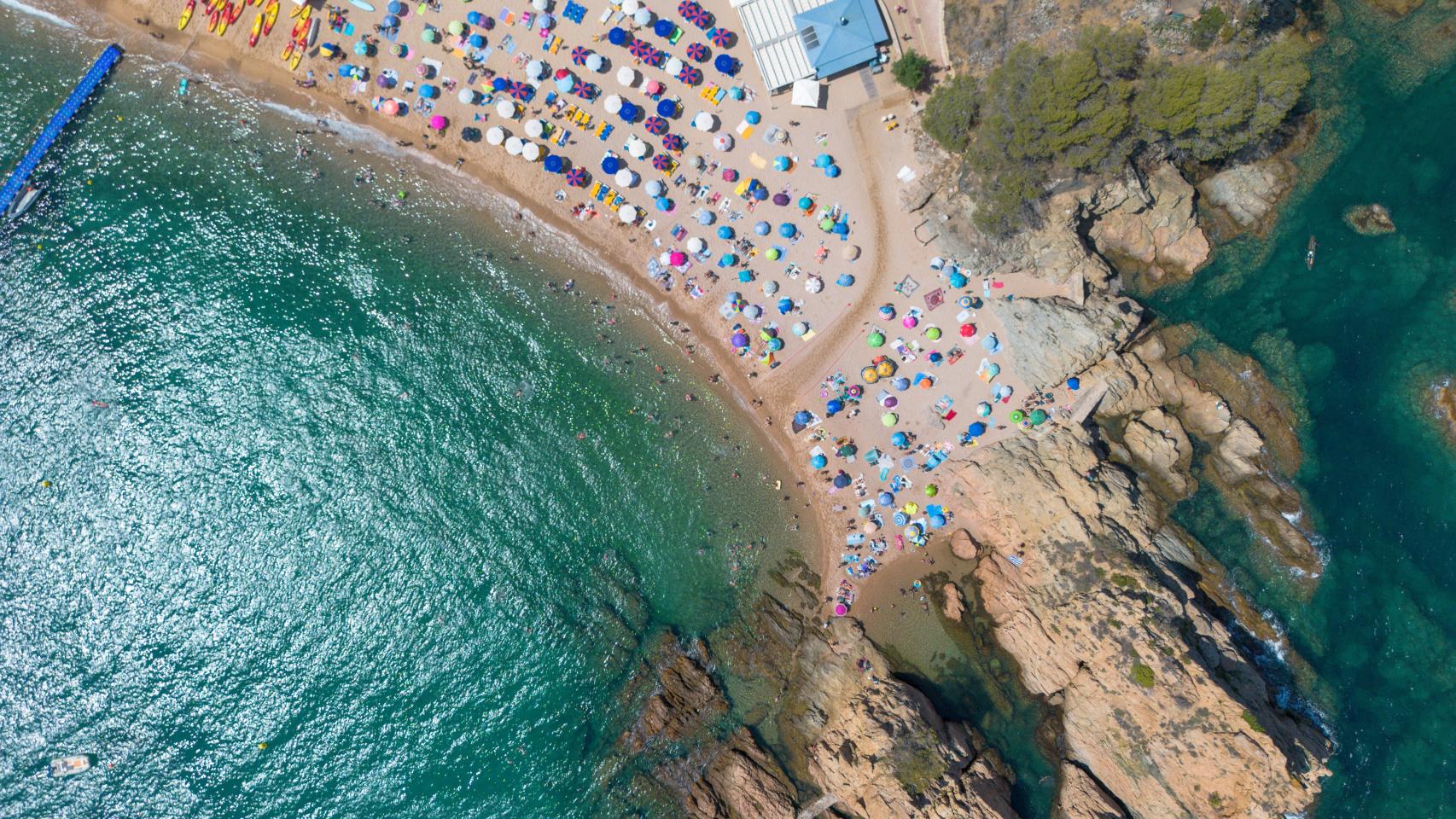 Numerosas personas disfrutan de un día de playa en la Costa Brava