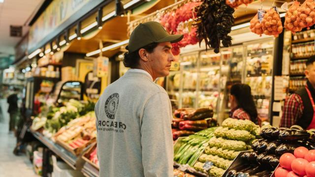 El chef Óscar Salmerón comprando en el puesto Frutas Charito del Mercado de Chamartín.