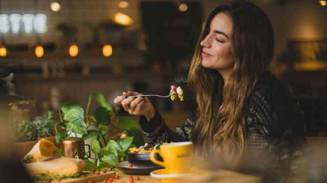 Mujer con un bonito cabello comiendo.