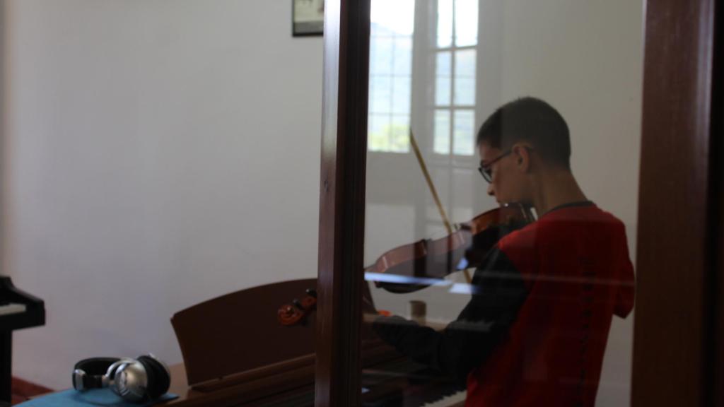 Uno de los escolanos practicando con el violín.