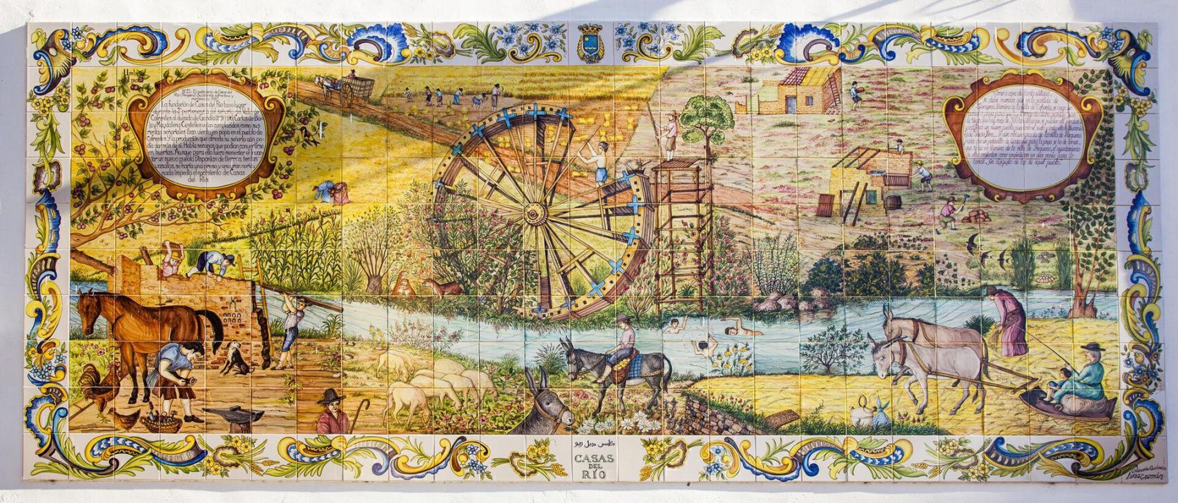 Retablo cerámico donde están representados los inicios de la aldea, así como la construcción de la noria. EE