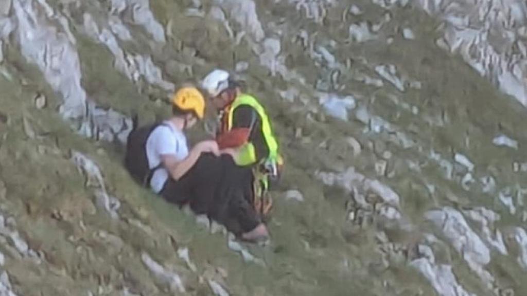 El rescatador auxiliando al montañero francés