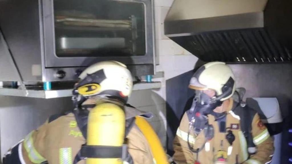 Los bomberos de Toledo trabajando en el interior del asador de pollos.