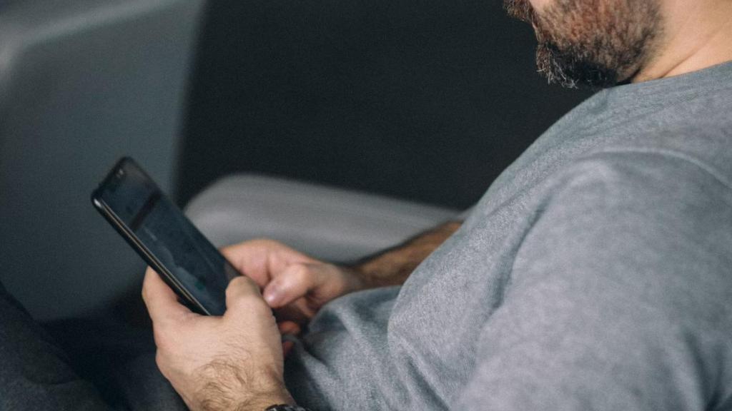 Persona mirando el móvil en el avión