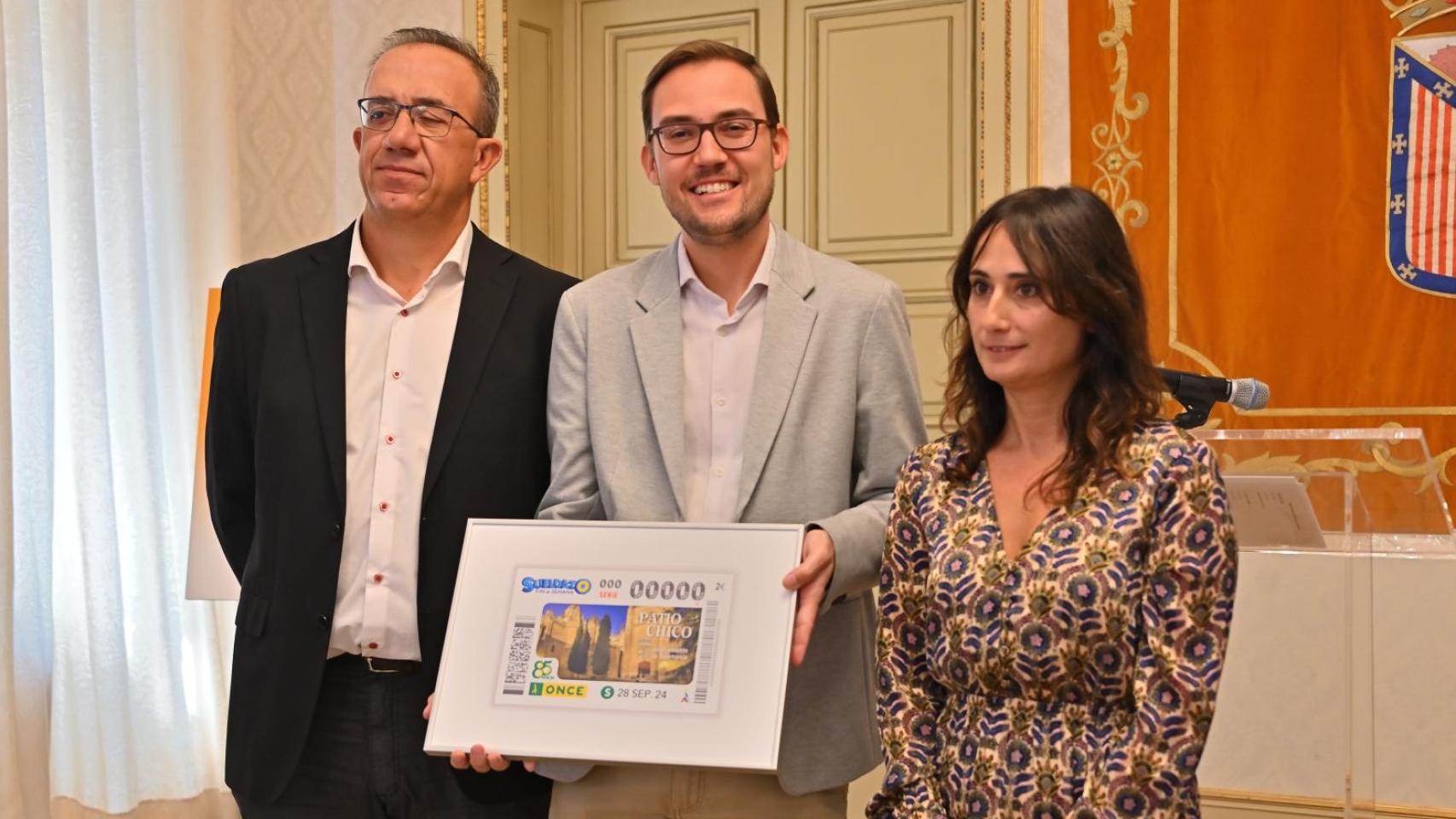 La directora de ONCE en Salamanca, Esther Pérez, el delegado territoral, Víctor Carreroa, y el concejal de Cultura, Ángel Fernández, han presentado esta mañana este cupón