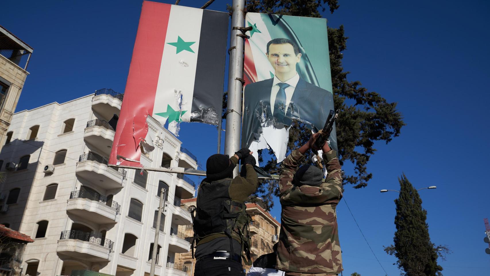 Combatientes de la oposición siria rompen un retrato del presidente sirio Bashar al-Assad en el centro de Alepo, Siria, el 30 de noviembre de 2024.