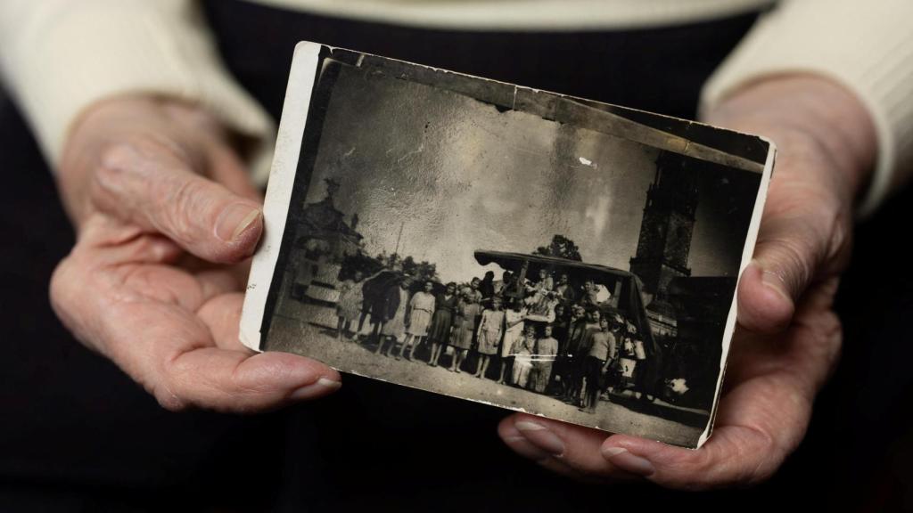 Iwanka holds an undated photograph of his way back to Poland during a photo shoot for Reuters ahead of the 80th anniversary of the liberation of the Nazi German concentration and extermination camp Auschwitz
