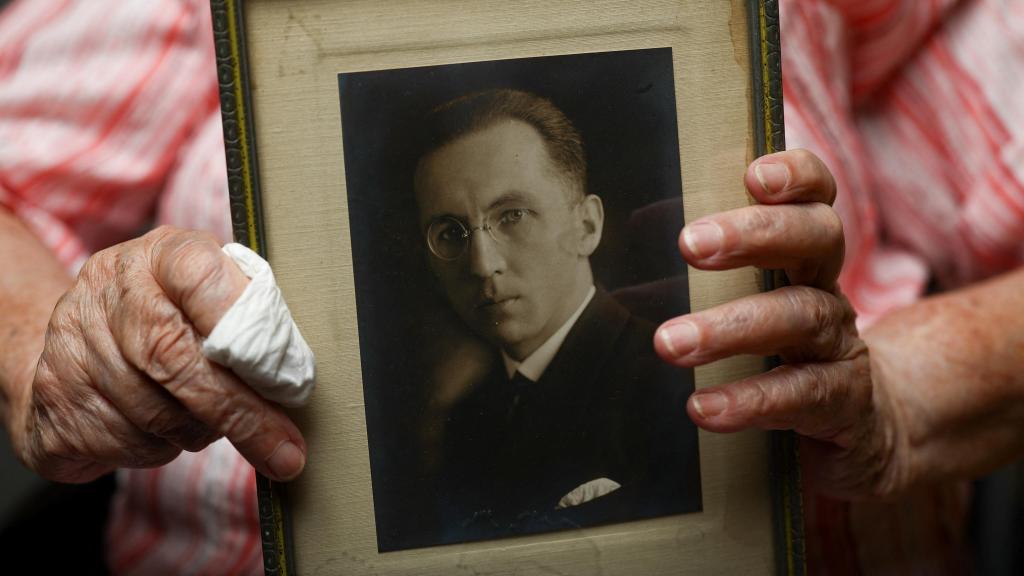 Regula holds a photograph of her father Jan Regula